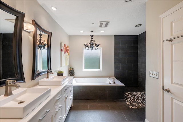 5973 Chesapeake Park Unit 58, Orlando, FL 32819 - bathroom featuring double vanity, plenty of natural light, a garden tub, a chandelier, and recessed lighting