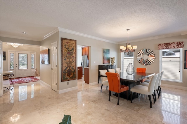 5973 Chesapeake Park Unit 58, Orlando, FL 32819 - dining area with a chandelier, a textured ceiling, ornamental molding, and light marble finish flooring