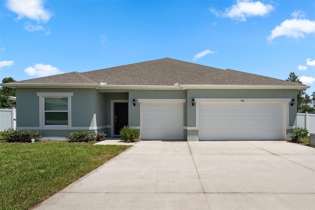 4811 SW 108th Place Rd, Ocala, FL 34476 - view of front of home with stucco siding, a garage, concrete driveway, and roof with shingles