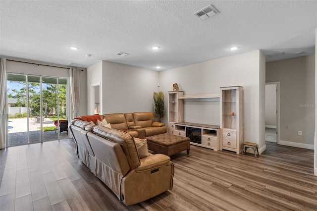 4811 SW 108th Place Rd, Ocala, FL 34476 - living area with wood finished floors, recessed lighting, a textured ceiling, and baseboards