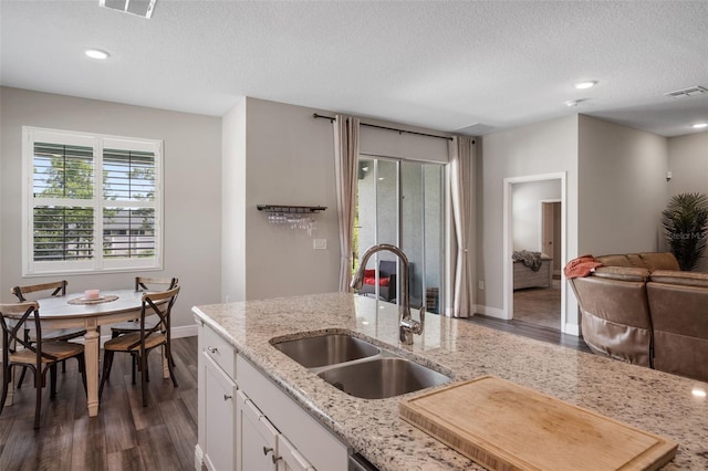 4811 SW 108th Place Rd, Ocala, FL 34476 - kitchen featuring a sink, dark wood-style flooring, baseboards, white cabinets, and a textured ceiling