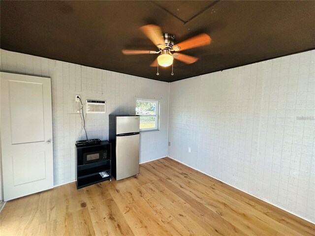 7904AND8010 SE US Highway 301, Hawthorne, FL 32640 - unfurnished room featuring light wood finished floors, ceiling fan, and a wall mounted air conditioner