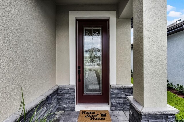 7745 Somersworth Dr, Kissimmee, FL 34747 - property entrance featuring stucco siding and stone siding
