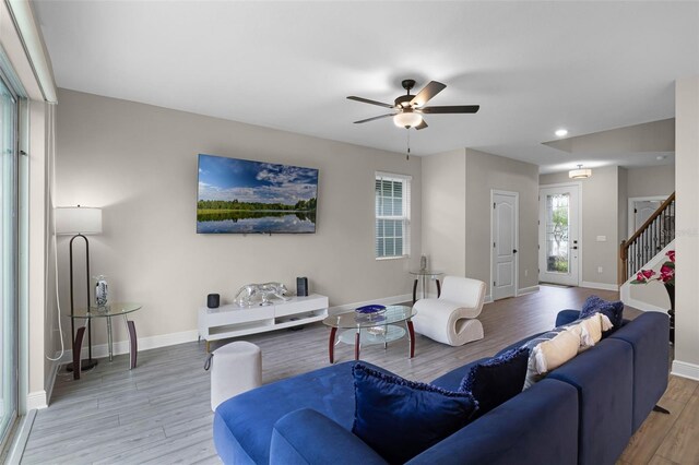 7745 Somersworth Dr, Kissimmee, FL 34747 - living room with wood finished floors, a ceiling fan, stairs, baseboards, and recessed lighting