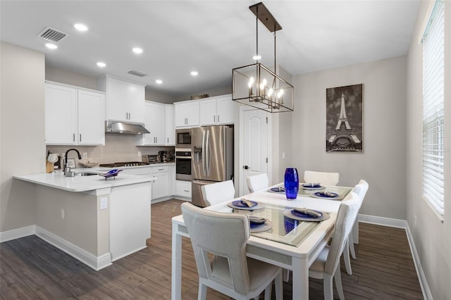 7745 Somersworth Dr, Kissimmee, FL 34747 - dining room with baseboards, dark wood finished floors, recessed lighting, and a chandelier