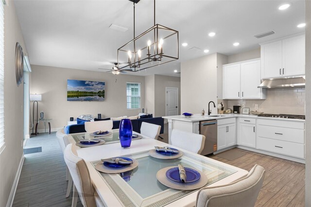 7745 Somersworth Dr, Kissimmee, FL 34747 - dining space with light wood-style floors, recessed lighting, baseboards, a chandelier, and ceiling fan
