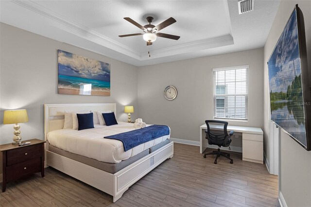 7745 Somersworth Dr, Kissimmee, FL 34747 - bedroom with a raised ceiling, light wood finished floors, ornamental molding, baseboards, and an office area