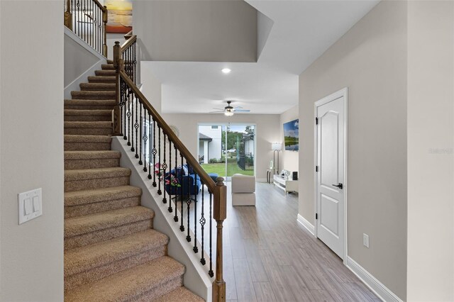 7745 Somersworth Dr, Kissimmee, FL 34747 - staircase featuring ceiling fan, wood finished floors, baseboards, and recessed lighting