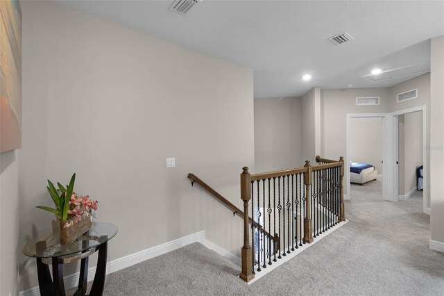7745 Somersworth Dr, Kissimmee, FL 34747 - corridor with an upstairs landing, carpet floors, recessed lighting, and baseboards