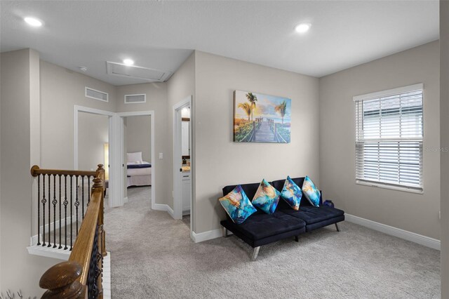 7745 Somersworth Dr, Kissimmee, FL 34747 - sitting room with light colored carpet, an upstairs landing, baseboards, recessed lighting, and attic access