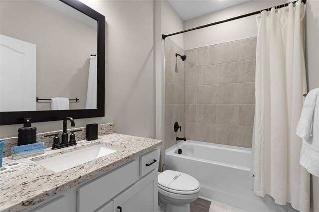 7745 Somersworth Dr, Kissimmee, FL 34747 - bathroom featuring vanity, toilet, and shower / bath combo with shower curtain