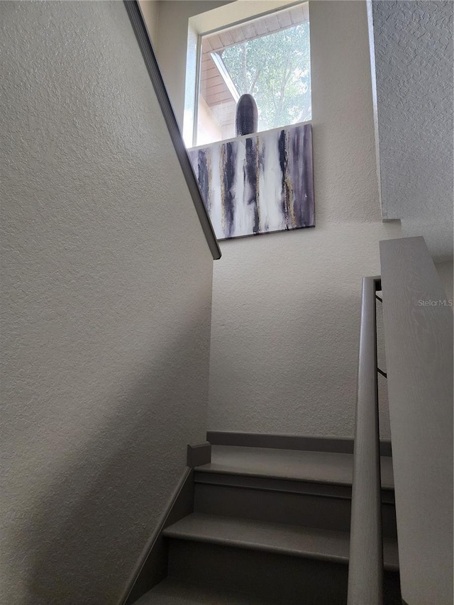 3500 Calabria Ave, Davenport, FL 33897 - staircase featuring a textured wall