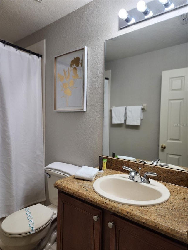 3500 Calabria Ave, Davenport, FL 33897 - full bathroom featuring a textured wall, toilet, vanity, and a textured ceiling