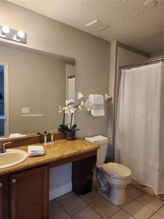 3500 Calabria Ave, Davenport, FL 33897 - bathroom with a textured ceiling, tile patterned floors, toilet, vanity, and a textured wall