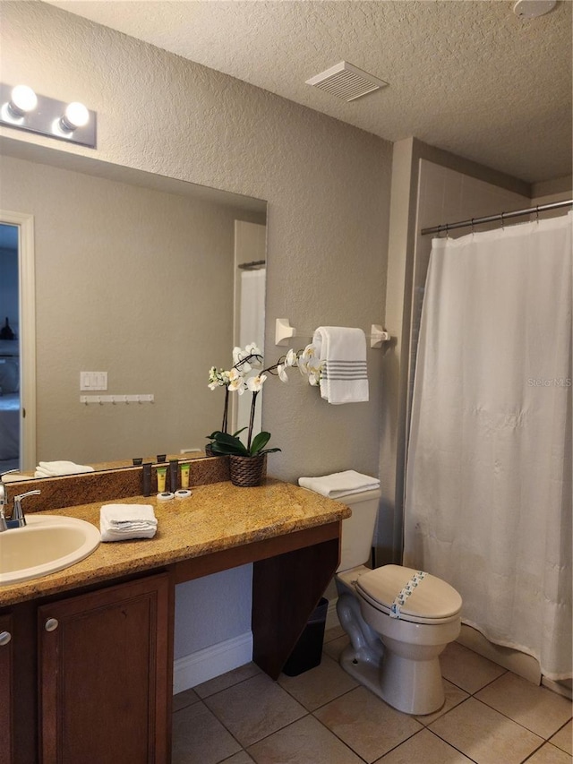 3500 Calabria Ave, Davenport, FL 33897 - bathroom with a textured ceiling, tile patterned flooring, toilet, vanity, and a shower with shower curtain