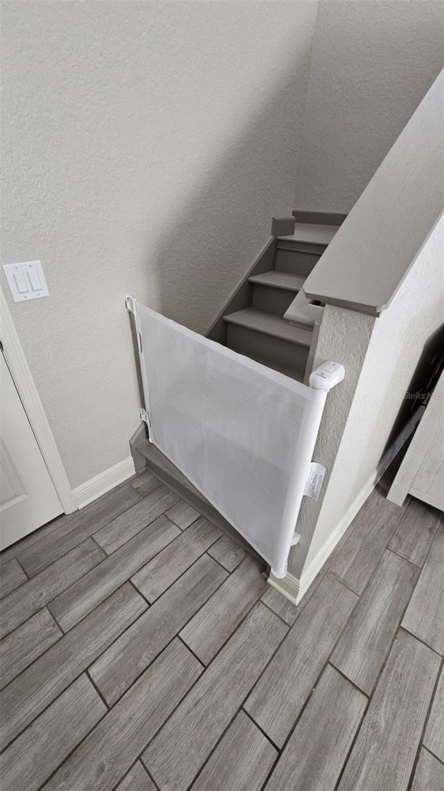 3500 Calabria Ave, Davenport, FL 33897 - staircase with wood finished floors, baseboards, and a textured wall