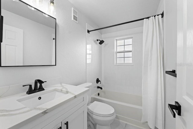 bathroom featuring toilet, vanity, and shower / bath combo