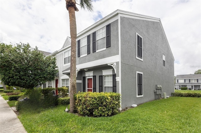 232 Countryside Key Blvd, Oldsmar, FL 34677 - view of side of property featuring stucco siding and a lawn