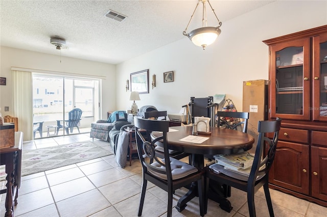 232 Countryside Key Blvd, Oldsmar, FL 34677 - dining area with light tile patterned flooring and a textured ceiling