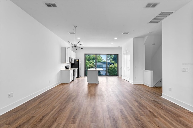 unfurnished living room featuring a chandelier, baseboards, recessed lighting, and dark wood-style flooring
