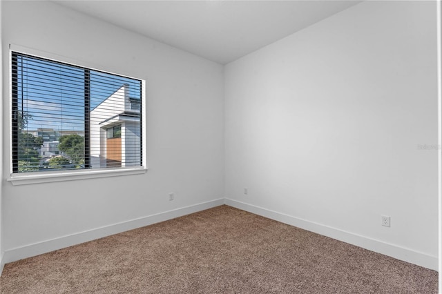 spare room with carpet flooring and baseboards