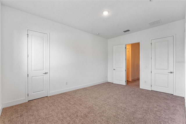 unfurnished bedroom featuring carpet flooring and baseboards