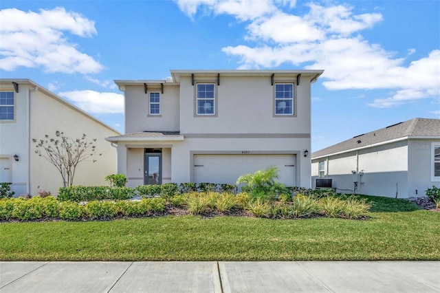 traditional home with stucco siding, a garage, and a front yard