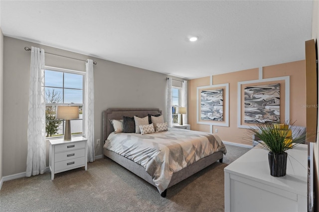 bedroom featuring carpet, multiple windows, and baseboards