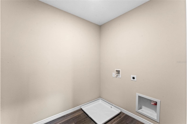 laundry room with electric dryer hookup, hookup for a washing machine, dark wood finished floors, and baseboards