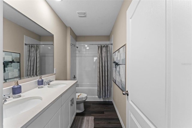 full bathroom with wood finished floors, shower / tub combo with curtain, toilet, and double vanity