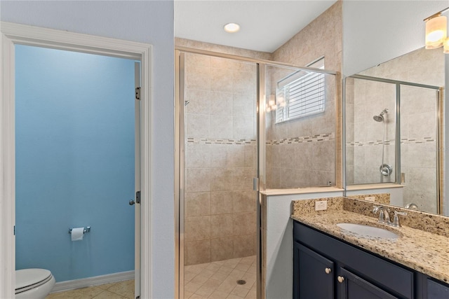 bathroom featuring a shower stall, vanity, and toilet