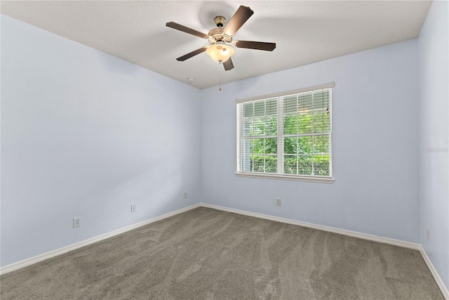 unfurnished room featuring a ceiling fan, carpet flooring, and baseboards