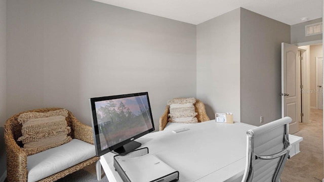 dining room featuring light carpet and a desk
