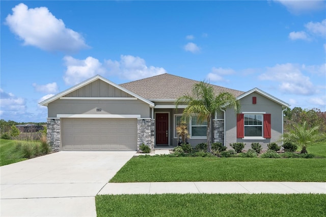 6139 Claystone Way, Mount Dora, FL 32757 - view of front of home with an attached garage, a front lawn, driveway, stone siding, and roof with shingles