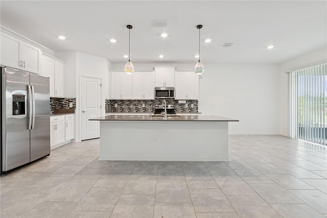 6139 Claystone Way, Mount Dora, FL 32757 - kitchen featuring appliances with stainless steel finishes, tasteful backsplash, recessed lighting, an island with sink, and white cabinetry