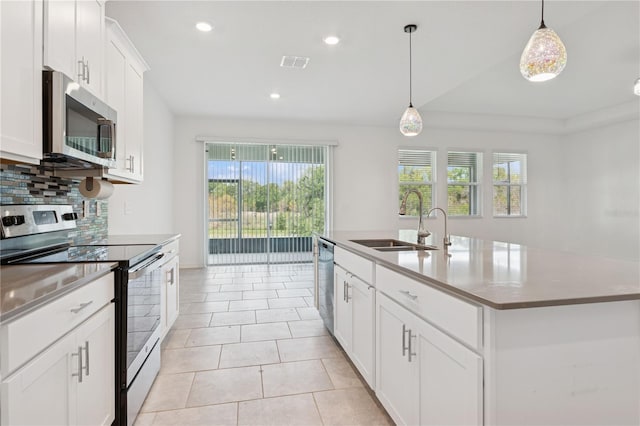 6139 Claystone Way, Mount Dora, FL 32757 - kitchen with appliances with stainless steel finishes, a sink, decorative backsplash, decorative light fixtures, and recessed lighting