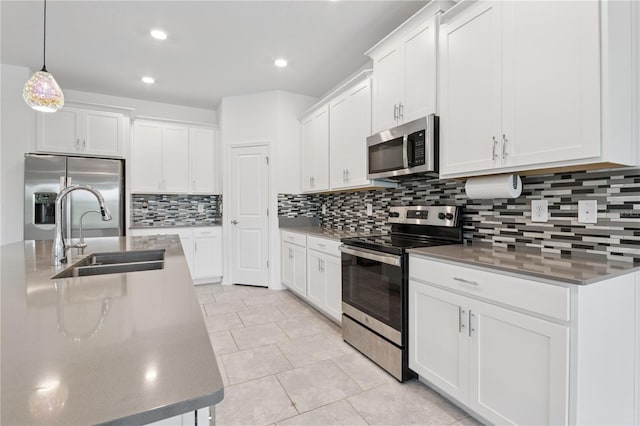 6139 Claystone Way, Mount Dora, FL 32757 - kitchen with stainless steel appliances, a sink, tasteful backsplash, white cabinets, and recessed lighting
