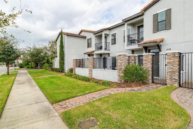 109 Kenny Blvd, Haines City, FL 33844 - view of property exterior featuring a gate, stucco siding, and stone siding
