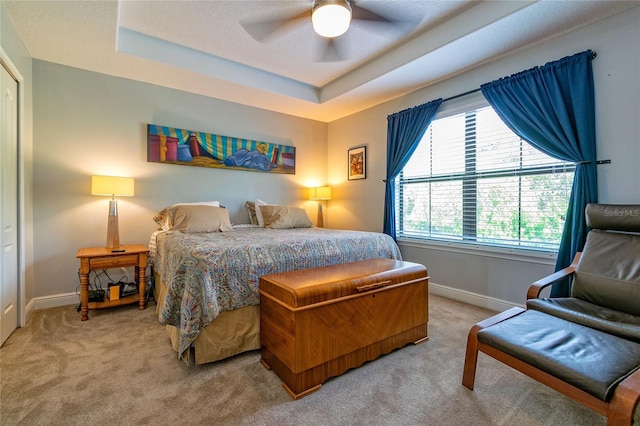 109 Kenny Blvd, Haines City, FL 33844 - bedroom with baseboards, a tray ceiling, light colored carpet, and ceiling fan