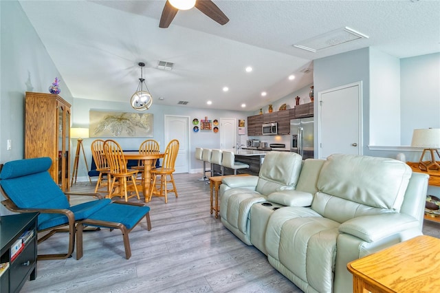 109 Kenny Blvd, Haines City, FL 33844 - living room with lofted ceiling, light wood finished floors, a ceiling fan, recessed lighting, and baseboards