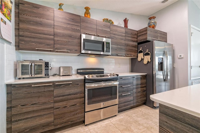 109 Kenny Blvd, Haines City, FL 33844 - kitchen featuring stainless steel appliances, decorative backsplash, light countertops, and light tile patterned floors