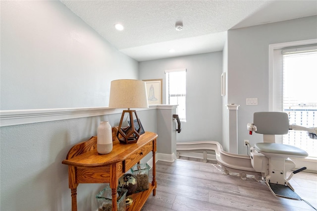 109 Kenny Blvd, Haines City, FL 33844 - corridor with wood finished floors, a textured ceiling, baseboards, and recessed lighting