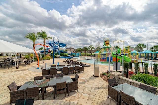 109 Kenny Blvd, Haines City, FL 33844 - view of patio featuring a water play area, fence, and a community pool