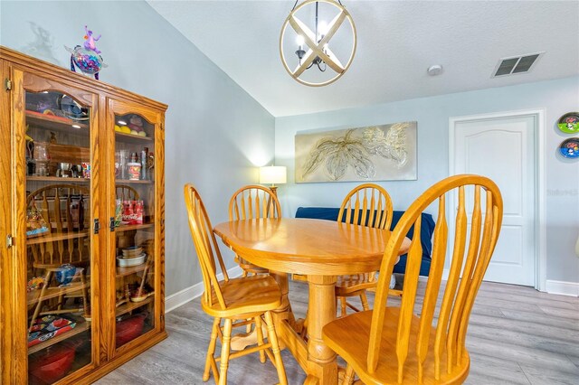 109 Kenny Blvd, Haines City, FL 33844 - dining space with light wood-style floors, baseboards, and lofted ceiling