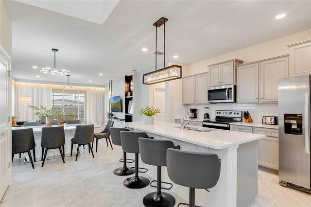 1221 Aloha Blvd, Davenport, FL 33897 - kitchen with stainless steel appliances, a sink, backsplash, a breakfast bar area, and recessed lighting
