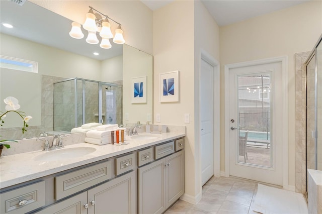 1221 Aloha Blvd, Davenport, FL 33897 - bathroom featuring tiled shower, a chandelier, double vanity, and tile patterned floors