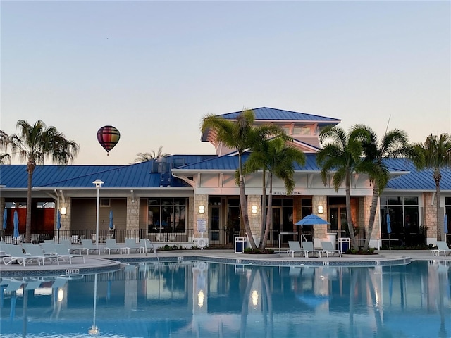 1221 Aloha Blvd, Davenport, FL 33897 - pool at dusk featuring a community pool and a patio