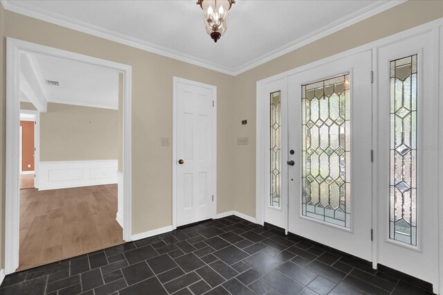 633 Balmoral Rd, Winter Park, FL 32789 - foyer entrance featuring ornamental molding and dark stone finish floors