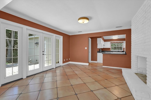 633 Balmoral Rd, Winter Park, FL 32789 - unfurnished living room featuring crown molding and baseboards