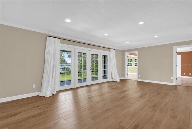 633 Balmoral Rd, Winter Park, FL 32789 - unfurnished living room featuring crown molding, french doors, baseboards, light wood finished floors, and recessed lighting